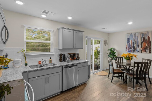 kitchen featuring range, gray cabinets, stainless steel dishwasher, and sink