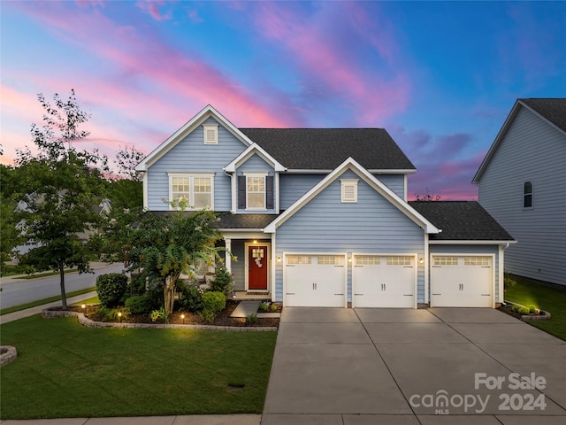 view of front of house featuring a lawn and a garage