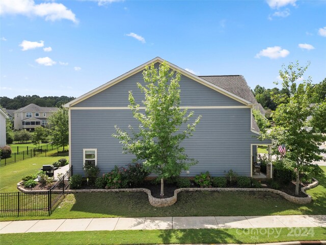 view of property exterior featuring a lawn