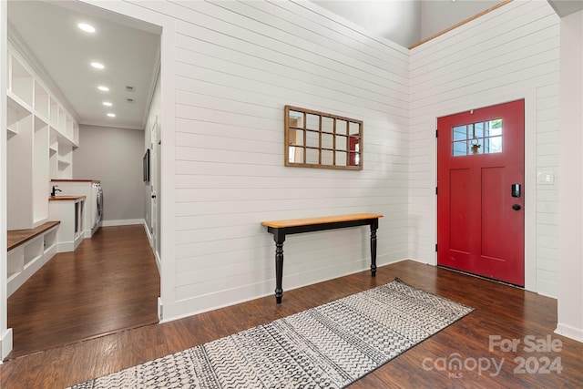 entrance foyer with a towering ceiling and dark hardwood / wood-style floors