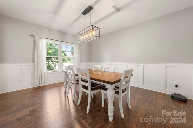 dining area with dark hardwood / wood-style flooring