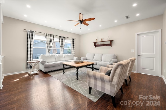 living room featuring ceiling fan and dark hardwood / wood-style floors