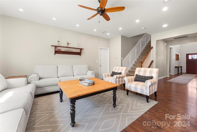 living room with dark wood-type flooring and ceiling fan