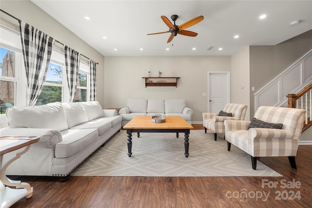 living room featuring ceiling fan and hardwood / wood-style flooring