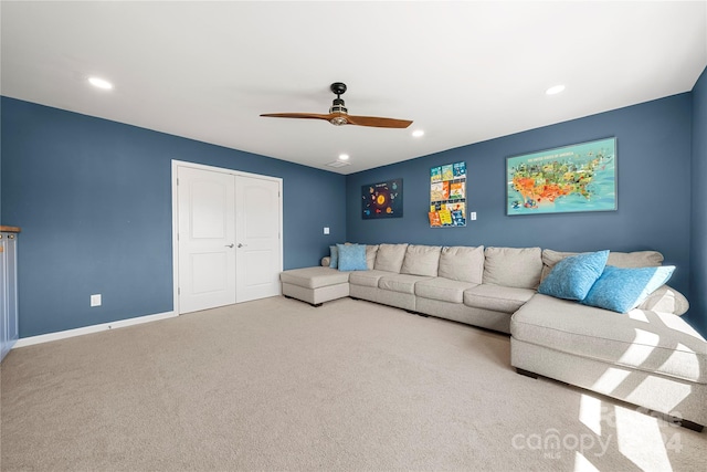 carpeted living room with ceiling fan