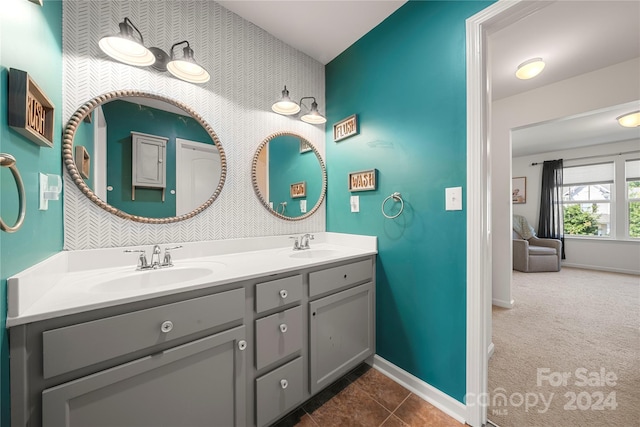 bathroom featuring tile patterned floors, lofted ceiling, and vanity