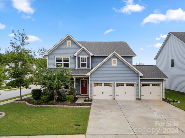 view of front of property featuring a garage and a front lawn