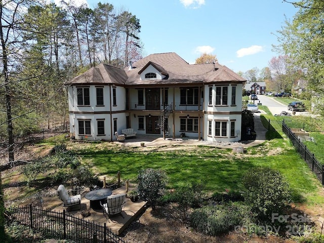 rear view of property featuring a patio area and a yard