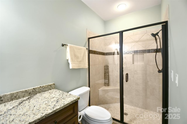 bathroom with toilet, an enclosed shower, and vanity