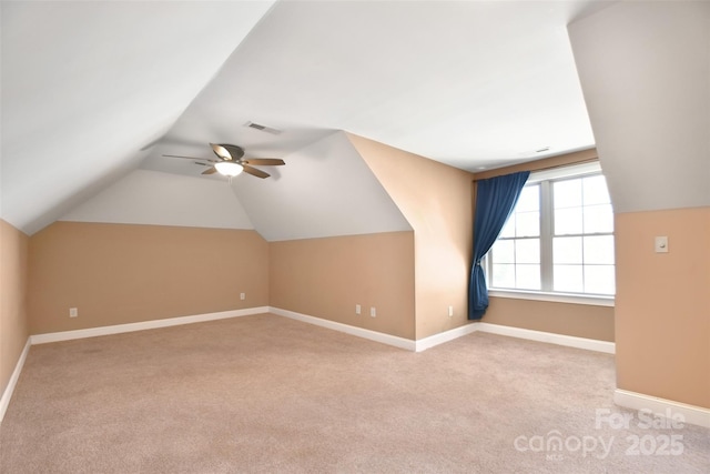 bonus room with light carpet, ceiling fan, and vaulted ceiling