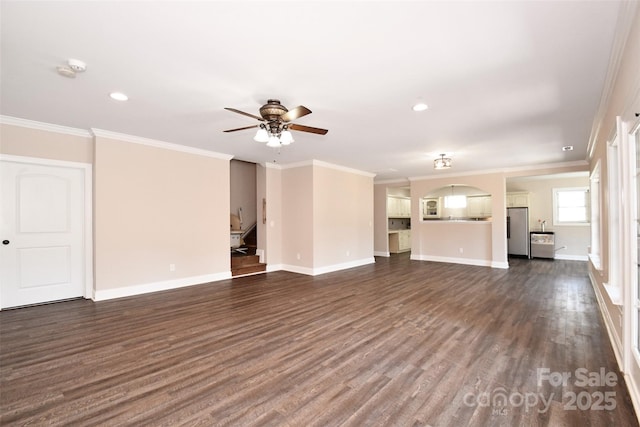 unfurnished living room featuring dark hardwood / wood-style floors, ceiling fan, and ornamental molding