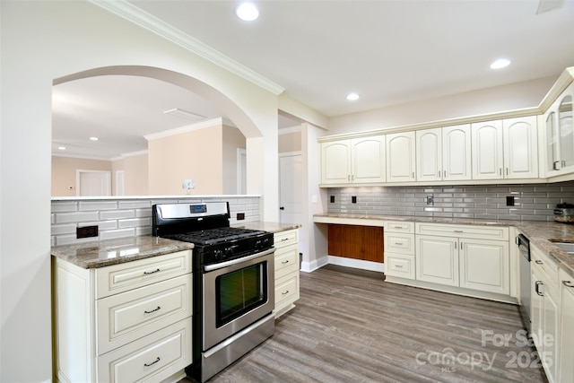 kitchen with light stone countertops, appliances with stainless steel finishes, dark hardwood / wood-style flooring, tasteful backsplash, and crown molding