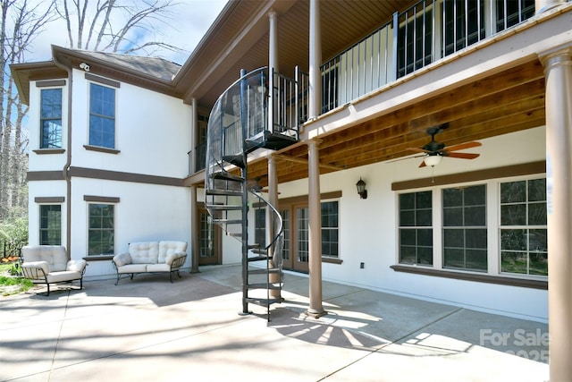 rear view of house featuring outdoor lounge area, ceiling fan, a patio area, and a balcony