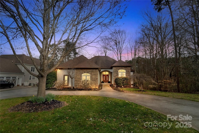 french provincial home featuring a lawn