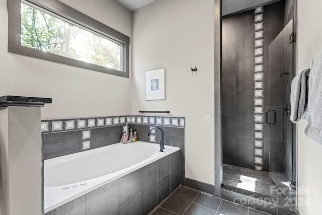 bathroom with tile patterned floors and plus walk in shower