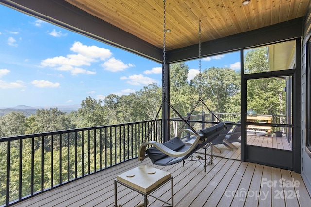 unfurnished sunroom featuring wooden ceiling