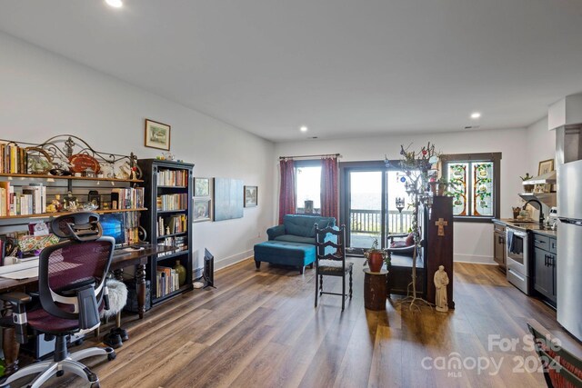 home office with dark hardwood / wood-style flooring