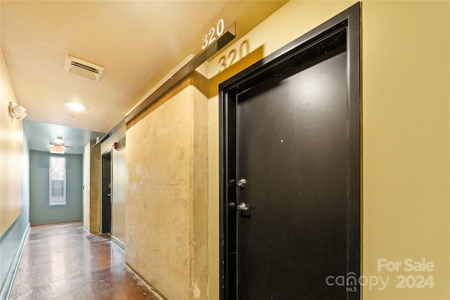 corridor with concrete flooring