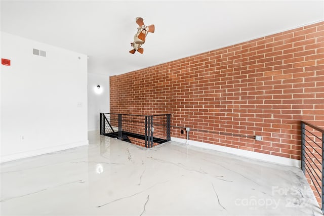 interior space with a fireplace and brick wall