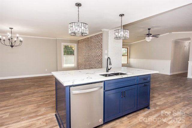 kitchen featuring ceiling fan with notable chandelier, dishwasher, sink, a kitchen island with sink, and ornamental molding