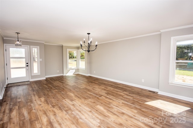 interior space featuring wood-type flooring, a chandelier, and crown molding