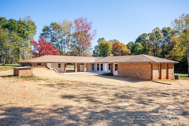 view of front of property featuring central AC unit and a patio