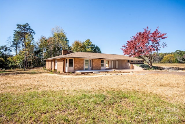 single story home with a patio area and a front lawn