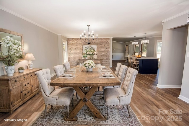 dining room featuring a chandelier, ornamental molding, and wood-type flooring