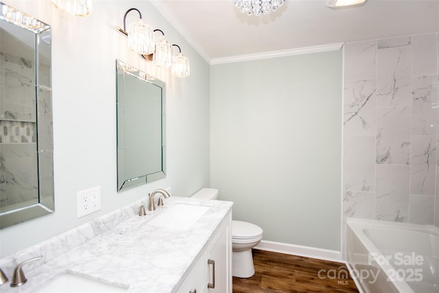 full bathroom featuring a notable chandelier, toilet, hardwood / wood-style floors, ornamental molding, and vanity