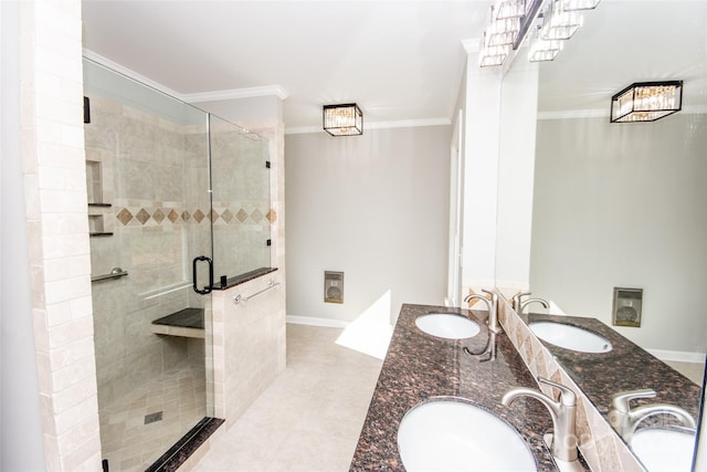 bathroom with vanity, a shower with shower door, ornamental molding, and tile patterned floors