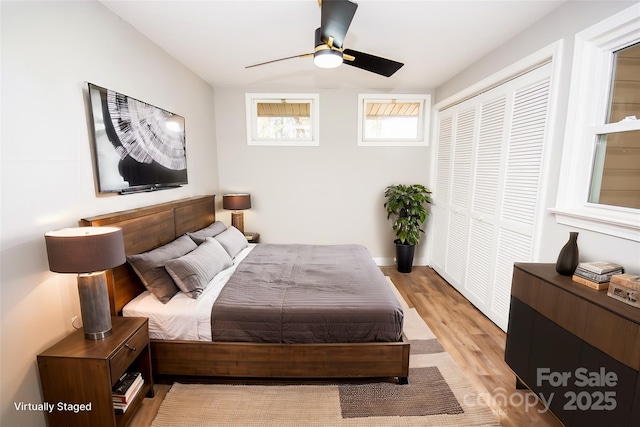 bedroom with a closet, ceiling fan, and light hardwood / wood-style floors