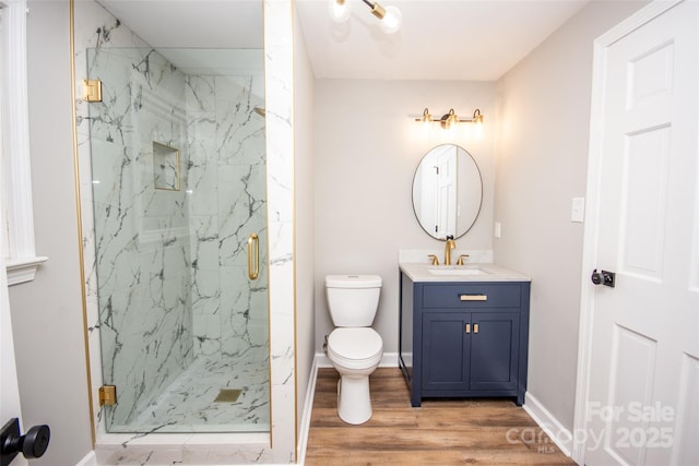 bathroom featuring vanity, hardwood / wood-style flooring, walk in shower, and toilet