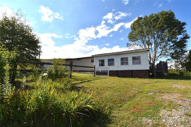 rear view of property with a yard