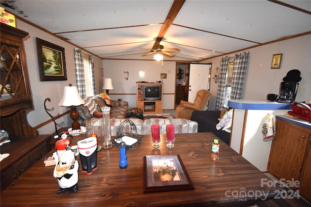 dining area with crown molding, vaulted ceiling, and ceiling fan