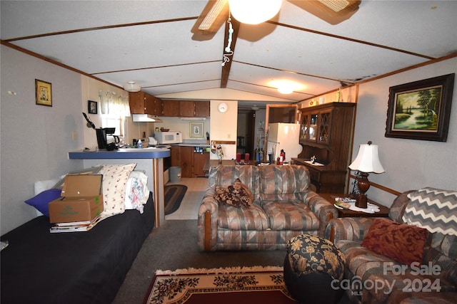 living room featuring lofted ceiling, crown molding, ceiling fan, and carpet floors