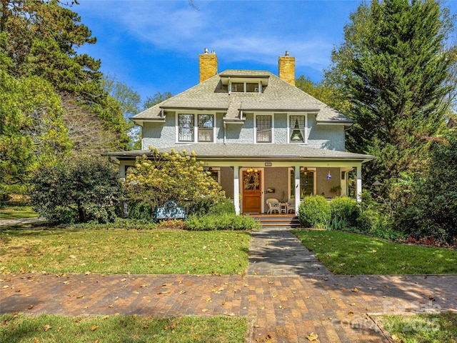 view of front of house with a porch and a front lawn