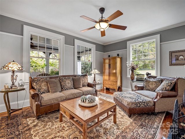 living room featuring wood-type flooring, ceiling fan, and crown molding