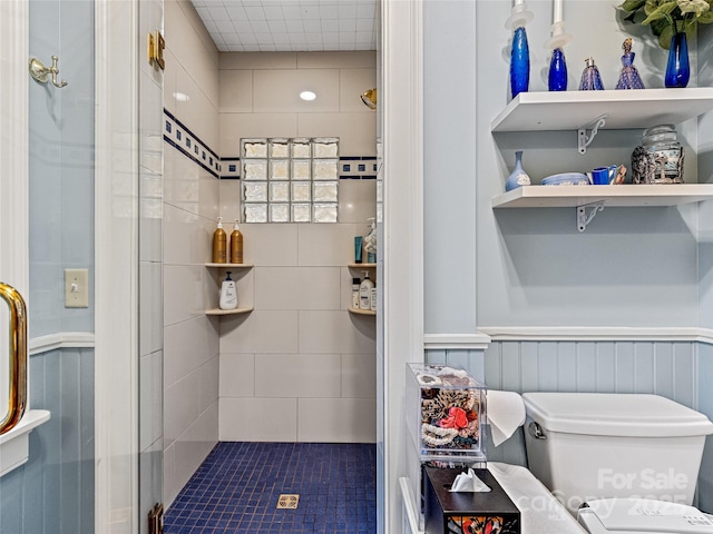 bathroom with an enclosed shower and toilet