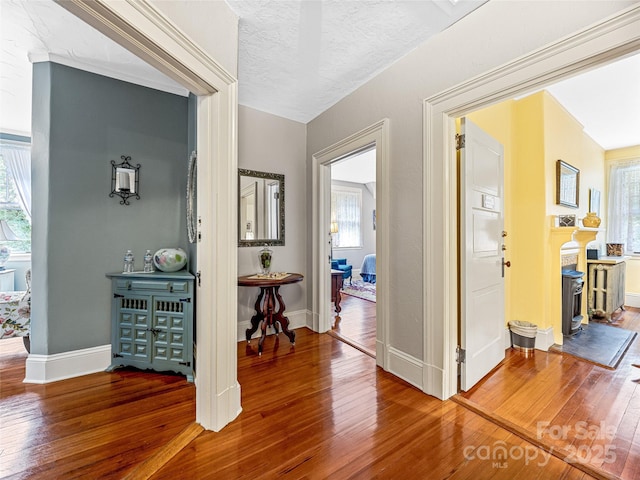 hall featuring a textured ceiling and hardwood / wood-style floors