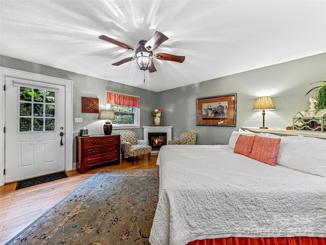 bedroom with ceiling fan and hardwood / wood-style flooring