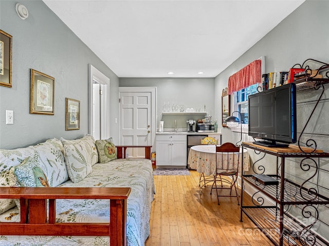 living room with sink and light wood-type flooring