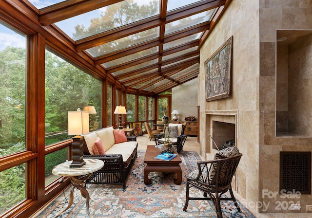 sunroom with vaulted ceiling with skylight and a healthy amount of sunlight