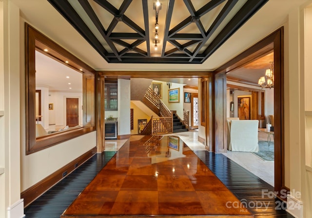 hall featuring an inviting chandelier and crown molding