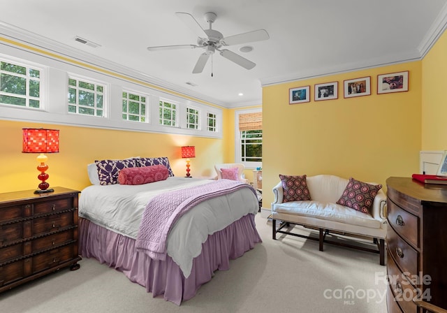 carpeted bedroom featuring ornamental molding and ceiling fan