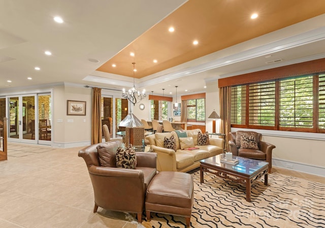 living room with crown molding, a tray ceiling, light tile patterned floors, and a notable chandelier