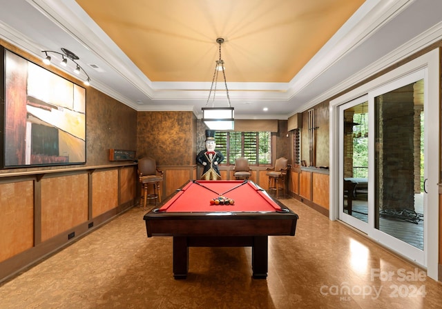 game room featuring pool table, a raised ceiling, and crown molding