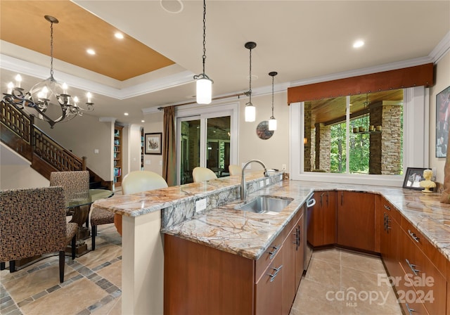 kitchen with ornamental molding, sink, kitchen peninsula, decorative light fixtures, and a chandelier