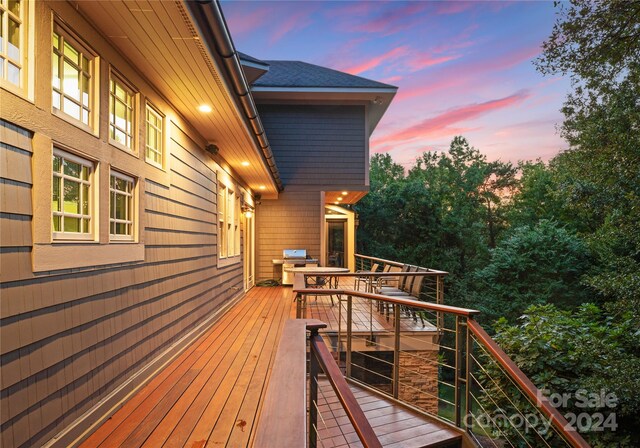 deck at dusk with grilling area