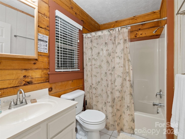 full bathroom featuring a textured ceiling, vanity, toilet, and wooden walls