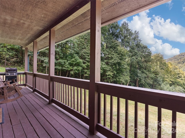 wooden deck featuring a yard